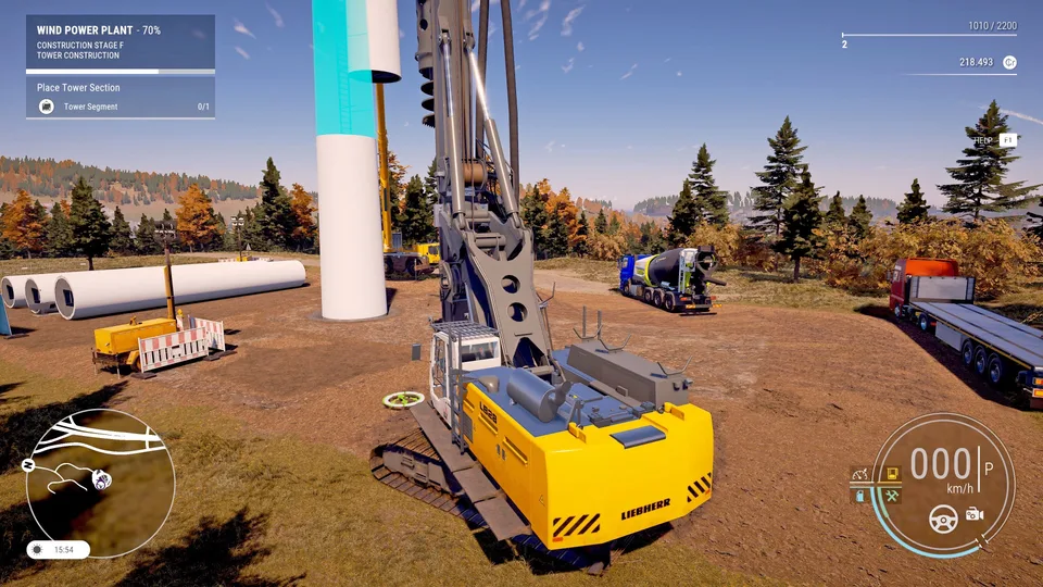 A yellow BELL articulated dump truck driving along a coastal highway toward the city skyline in Construction Simulator